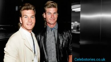 "A duo of smiling men, one in a light suit and the other in a leather jacket, captured in a stylish black and white photo.